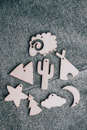 Wooden toy silhouette lamb, star, month, mountain, cactus, Christmas tree on grey backgroundの写真素材