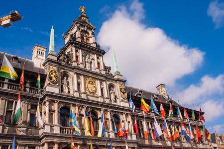 Antwerp city hall with flags of all Nations on a Sunny dayの写真素材