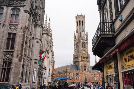 View of Belfort tower from the market square. Bruges, Brussels, on a cloudy dayの写真素材