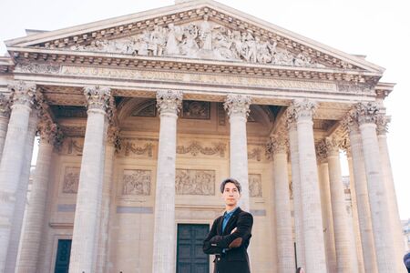a young man stands on the square in front of the Pantheon, Paris, France