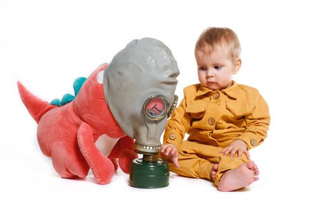 a small boy in a yellow suit with a gas mask, isolated on a white backgroundの写真素材