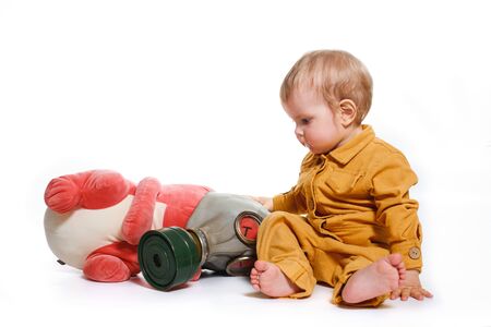 a small boy in a yellow suit with a gas mask, isolated on a white backgroundの写真素材