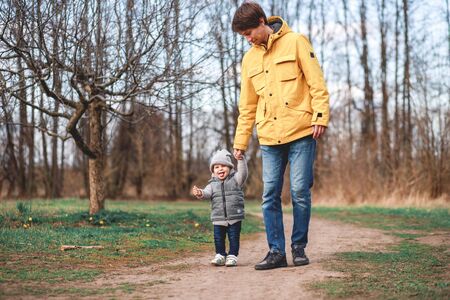 a man takes his child to kindergarten while walking in the Parkの写真素材