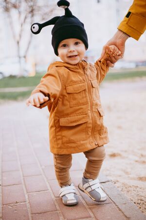 a child in a hat a snail with eyes on the street backgroundの写真素材