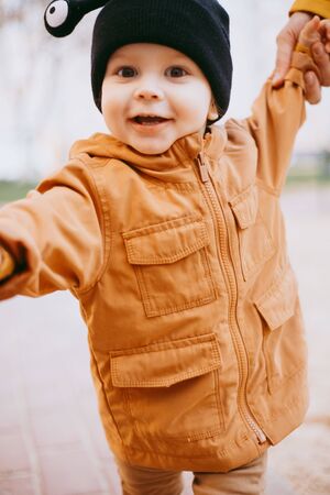 a child in a hat a snail with eyes on the street backgroundの写真素材