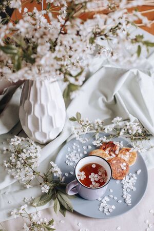 spring healthy Breakfast fried cheesecakes, against a blooming bouquet of white flowers