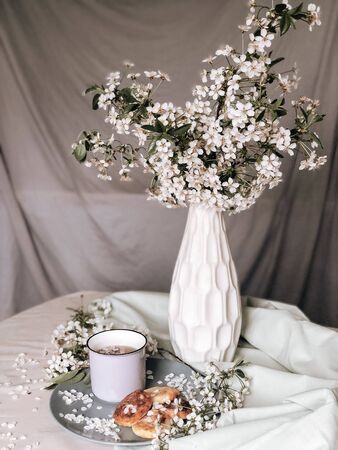 spring healthy Breakfast fried cheesecakes, against a blooming bouquet of white flowersの写真素材