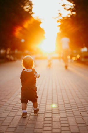 Baby runs along the Boulevard silhouetteの写真素材
