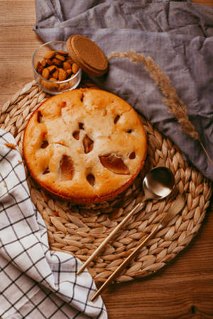 Homemade galette with pears and nuts on wooden rustic background. Sweet open fruit pie. Autumn...