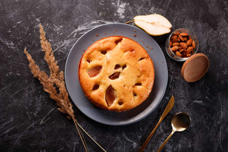 Homemade pear cake, on a black metal background.Flat lay.の写真素材
