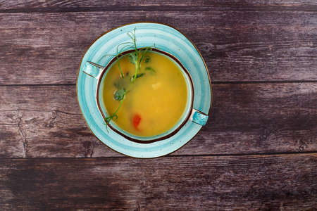 Carrot soup on a wooden tableの写真素材