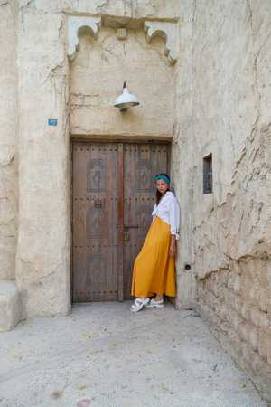 Tourist girl walking at the streets of old Arabian town in Dubai, UAE