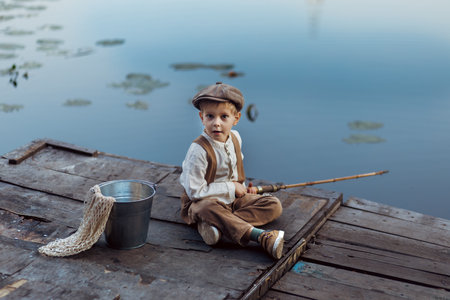 Little boy fishing at sunsetの写真素材