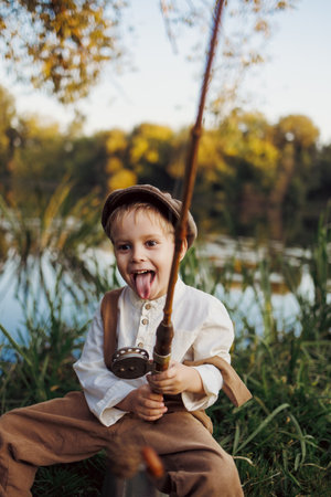 Little boy fishing at sunsetの写真素材