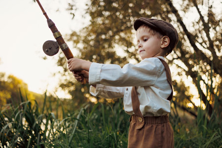 Child fishing at autumn lakeの写真素材