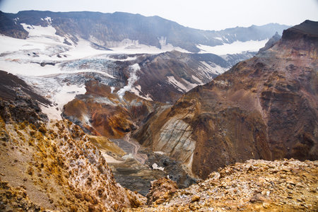 Beautiful mountain landscape, crater of active volcano: fumarole and hot spring, geothermal gas-steam activity, lava plain. Amazing volcanic landscape, travel destinations for hike, mountain climbing.の写真素材