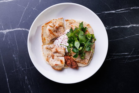 Creamy Chicken Flatbread Plate With Yogurt Sauce, Parsley, And Fresh Herbsの写真素材