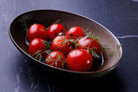 Fresh Red Tomatoes in a Rustic Bowl Garnished with Dillの写真素材
