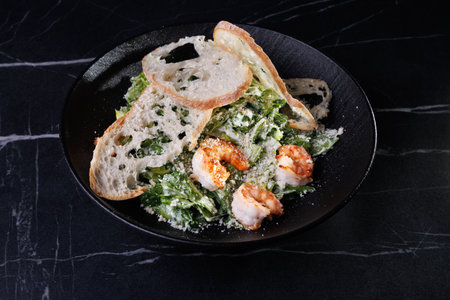 Creamy Shrimp Pasta With Greens and Toasted Bread On a Black Plate Studio Styleの写真素材