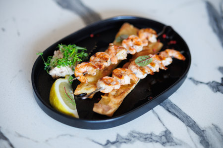 Creamy Shrimp Pasta With Greens and Toasted Bread On Plate Studio Styleの写真素材
