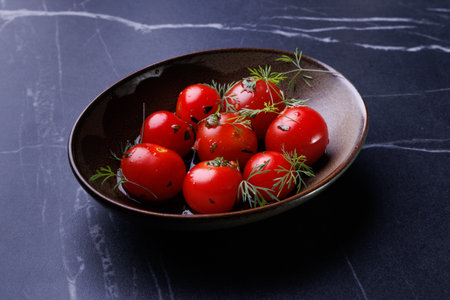 Fresh Red Tomatoes in a Rustic Bowl Garnished with Dill and Herbs for Healthy Freshnessの写真素材