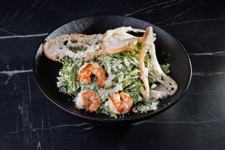 Creamy Shrimp Pasta With Greens and Toasted Bread On a Black Plate Studio Styleの写真素材