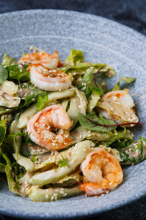 Shrimp Salad with Fresh Herbs on a Gray Plate, on a Dark Backgroundの写真素材