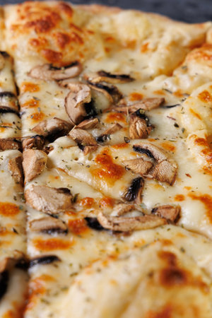 Gourmet Mushroom Cheese Pizza On Circular Wooden Board, Freshly Baked and Ready to Serveの写真素材