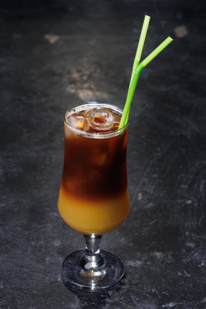 Iced Coffee Layered Drink in Glass with Green Straws, Refreshing Cold Beverage