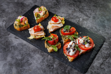 Elegant platter of bite-sized crostini topped with tomato, cheese, basil, and seafood. Ideal for...