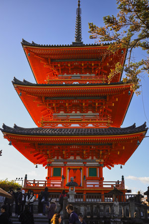 Kyoto. Bright Red Roof of a Japanese Temple with ornate wooden trim and stone steps under a clear skyの写真素材