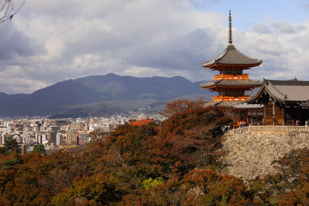 .Autumn Pagoda Overlooking City From Hilltop, Traditional Japanese Temple in Kyoto With Red Foliageの写真素材