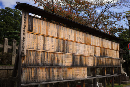 Rows Of Weathered Wooden Slats With Japanese Kanji Inscriptions At A Traditional Shrineの写真素材