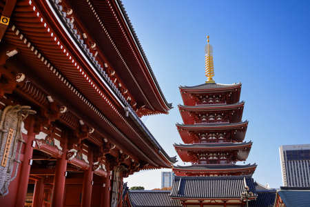 Iconic Japanese temple scene featuring a towering red pagoda beside ornate wooden roofs under a...