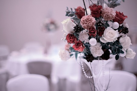 Christmas wedding bouquet with red rose on the tableの写真素材