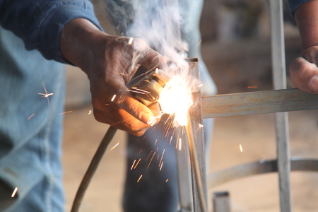Worker welding the steel