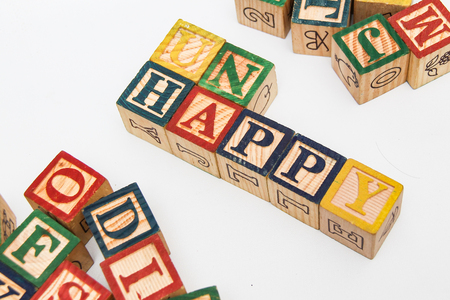 The arrangement of letters forms one word, "UNHAPPY"の写真素材