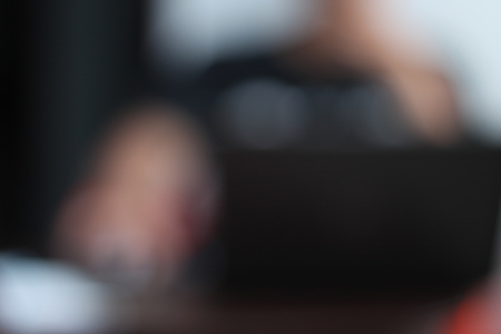 in front of the laptop (blur image)の写真素材