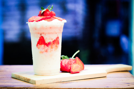 milkshake with strawberry pieces, in  plastic cup, delicious and fresh.の写真素材