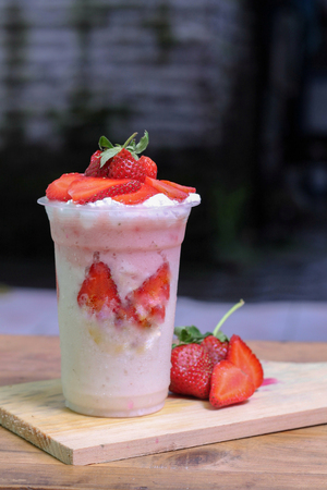 milkshake with strawberry pieces, in  plastic cup, delicious and fresh.の写真素材