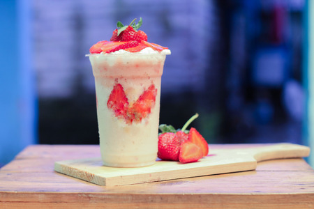 milkshake with strawberry pieces, in  plastic cup, delicious and fresh.の写真素材