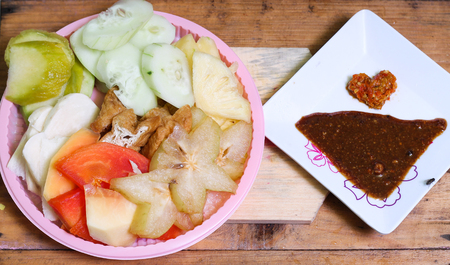 Indonesian traditional snack, (Rujak manis : Indonesian spelling), consists of slices of pineapple, raw mango, jicama, cucumber, Ambarella, star fruit, papaya and fried tofu.の写真素材