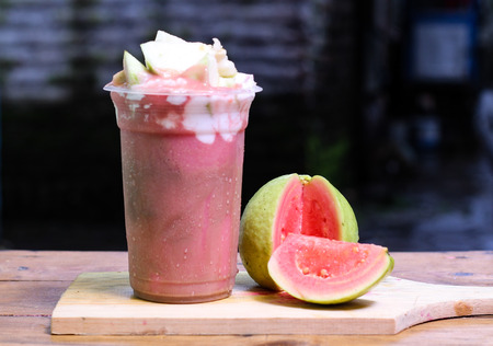 milkshake with guava pieces, in  plastic cup, delicious and fresh.の写真素材
