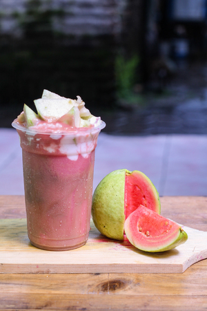 milkshake with guava pieces, in  plastic cup, delicious and fresh.の写真素材