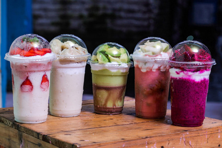 milkshake with flavor variant : strawberry, durian, avocado, guava, dragon fruit. In plastic cup, Delicious and fresh.の写真素材