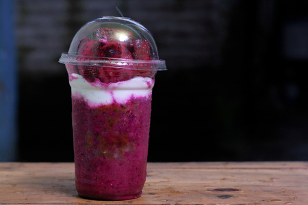 milkshake with dragon fruit pieces, in plastic cup, delicious and fresh.の写真素材
