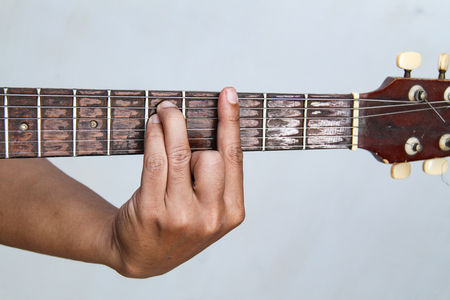 Playing guitar, in chord G minorの写真素材