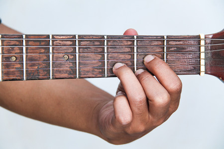 playing guitar, in chord D majorの写真素材