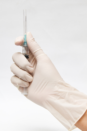 holding a injection syringe 3 cc with hand glove (one hand technique)の写真素材