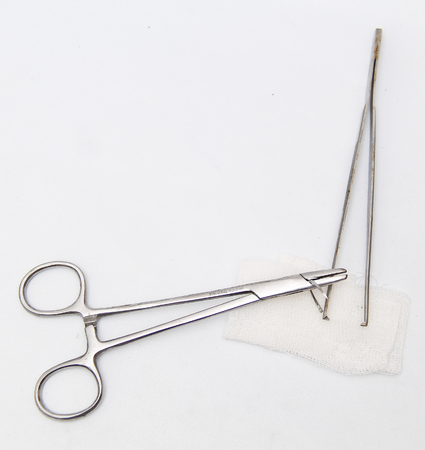 a surgery needle (straight 1/2 circle), needle holder and bandageの写真素材